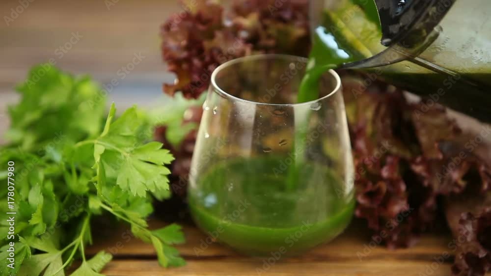 parsley and celery juice in glass on a wooden table parsley and celery juice in glass on a wooden table