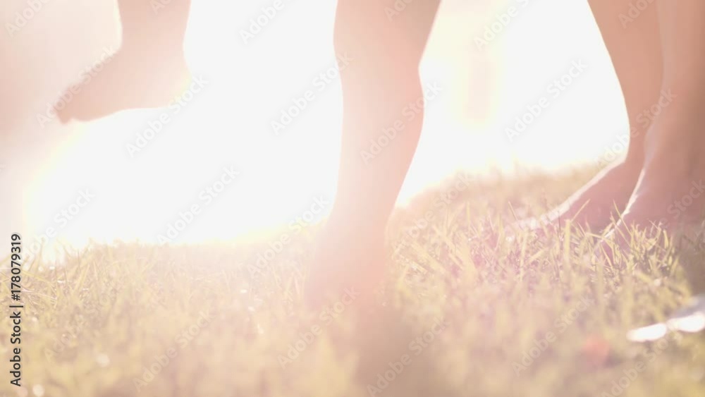 Little baby learns to walk. First Steps. Slow Motion 120 fps, 4K. Mother is teaching her child to do the first steps on a green grass in summer. Close up on feet. Happy childhood and Maternity. Family Little baby learns to walk. First Steps. Slow Motion 120 fps, 4K. Mother is teaching her child to do the first steps on a green grass in summer. Close up on feet. Happy childhood and Maternity. Family