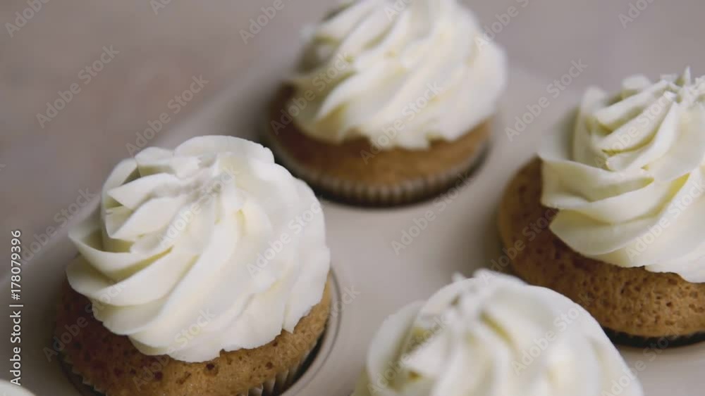 Cup-cakes with cream. Butter cream on tasty muffins, home bakery concept. Slide effect Cup-cakes with cream. Butter cream on tasty muffins, home bakery concept. Slide effect