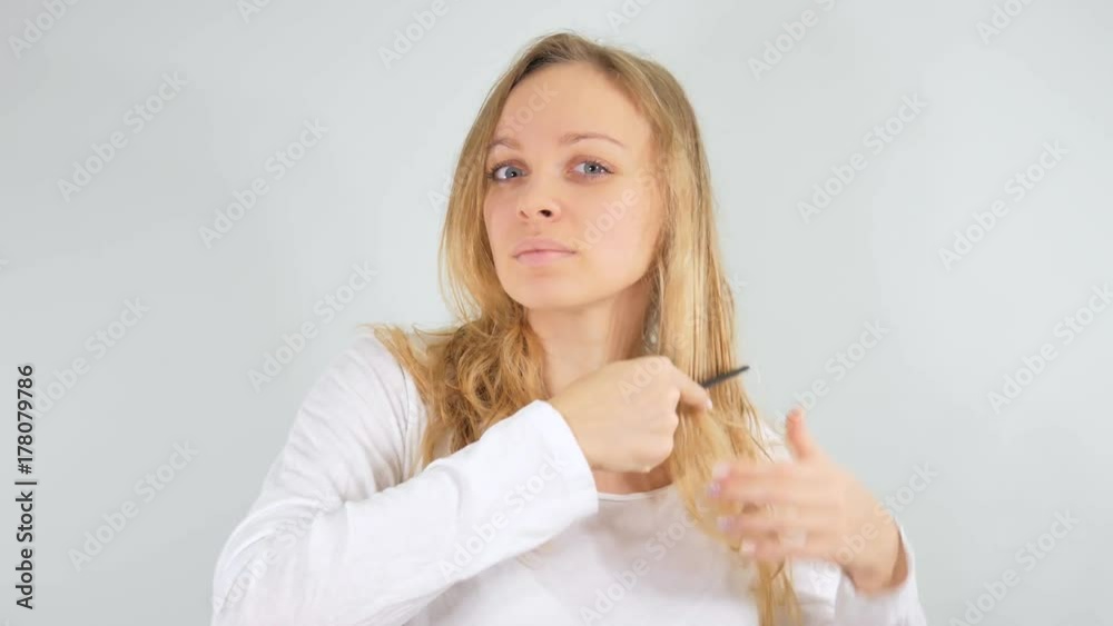 4k Girl combing her wet hair in front of the mirror . Isolated on white background. 4k Girl combing her wet hair in front of the mirror . Isolated on white background.