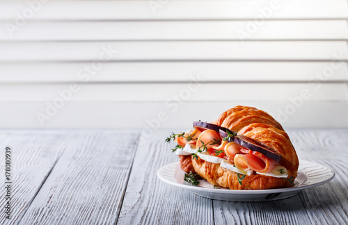 Fresh Croissant Sandwich with Ham, Cheese, Thyme and figs Breakfast Delicious Baking Refreshment Copy space for Text