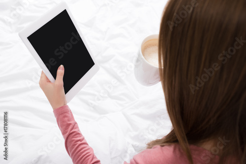 woman with coffee and tablet
