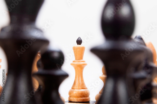 Black chess pieces and white king