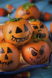 tangerines ornamented as carved pumpkins