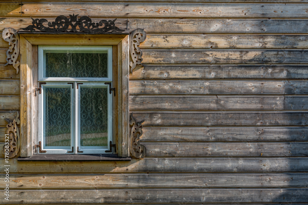 The old window of old wooden house. Background of wooden walls The old window of old wooden house. Background of wooden walls