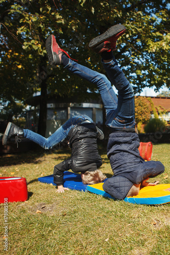 children stand on the head in the Park photo