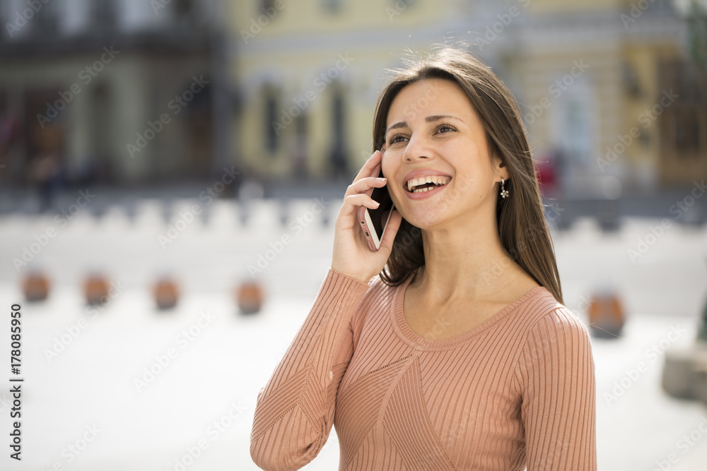 Beautiful young brunette woman calling by phone Beautiful young brunette woman calling by phone