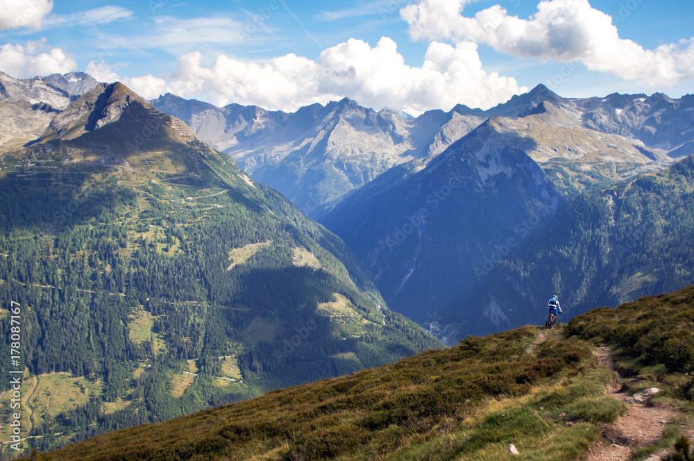 A mountain biker does off-road mountain biking in the Gastein region of Austria. A mountain biker does off-road mountain biking in the Gastein region of Austria.