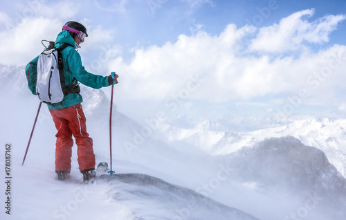 A skier takes a break to enjoy the beautiful view at the Hintertuxer ski region in Tyrol, Austria. photo