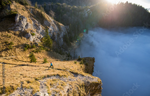 A young woman does mountain running or a trail run at the beautiful Nockstein mountain in Salzburg, Austria.