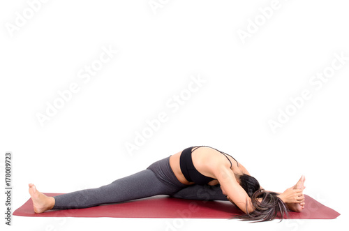 Fototapeta Naklejka Na Ścianę i Meble -  young asian woman doing yoga stretching pose on the mat isolated on white background, exercise fitness, sport training, healthy lifestyle and people concept