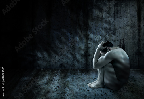 Man surrounded by darkness photo