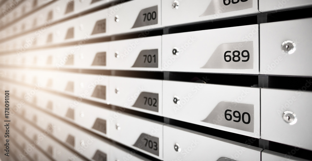 Mail boxes filled of leaflets and letters. Shallow DOF,Mailboxes and Lock in Rows at Entrance. Mail boxes filled of leaflets and letters. Shallow DOF,Mailboxes and Lock in Rows at Entrance.