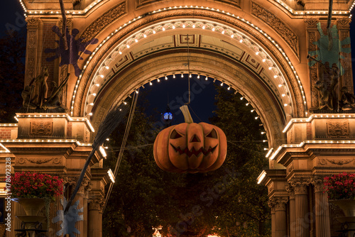 Photography Halloween pumpkin in front of the illuminated main entrance to Tivoli Gardens, C