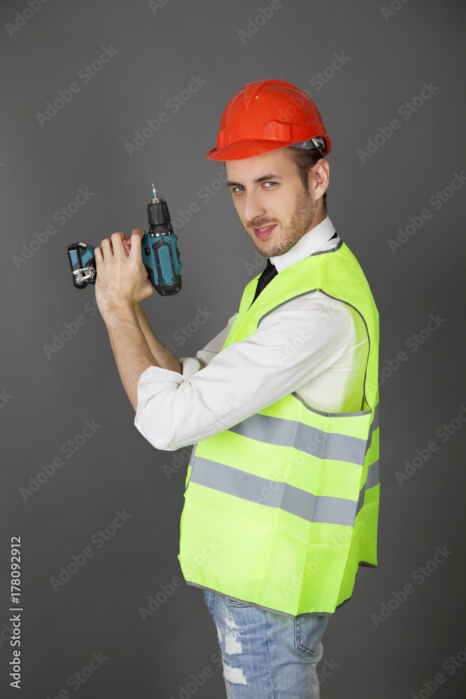 Builder holding a drill like a gun Builder holding a drill like a gun