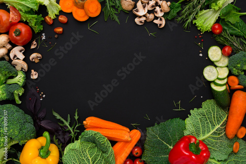 Plenty of fresh vegetables on black background with copy space