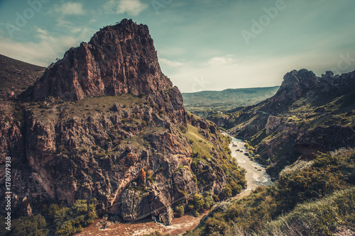 Mountain river stream in canyon valley. Panoramic Nature landscape. Travel background. Holiday, hiking, sport, recreation. Retro vintage toning effect.