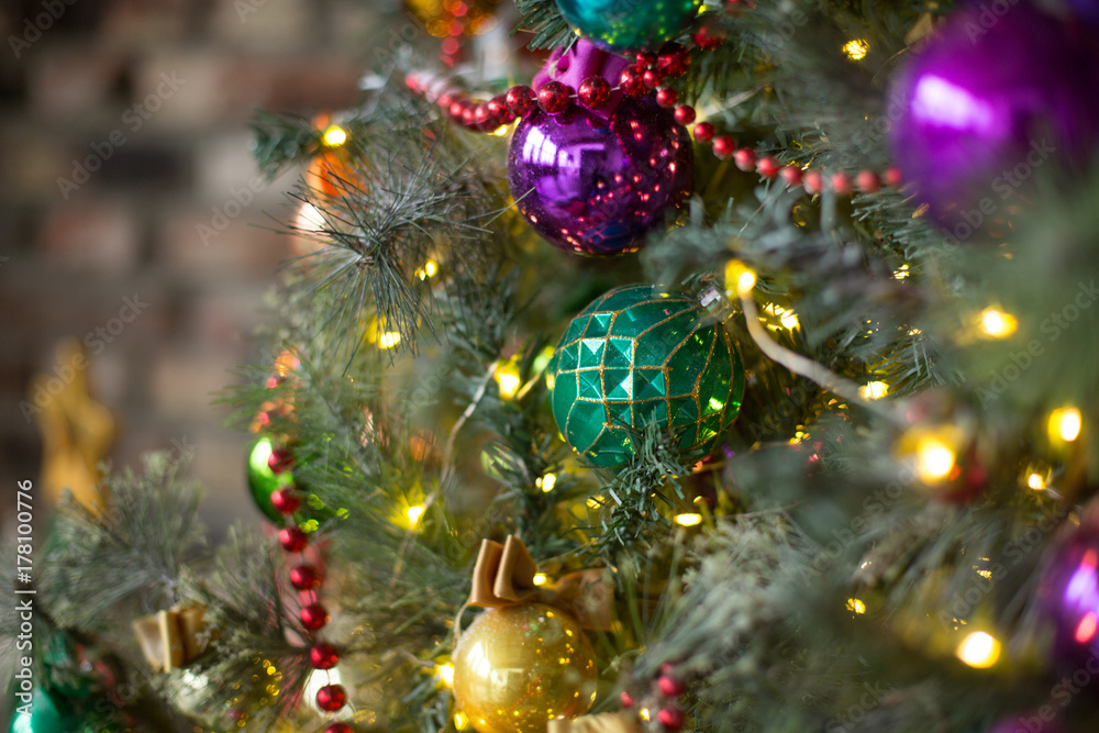 Xmas toys on the Christmas tree. Shiny balls. New Year mood.