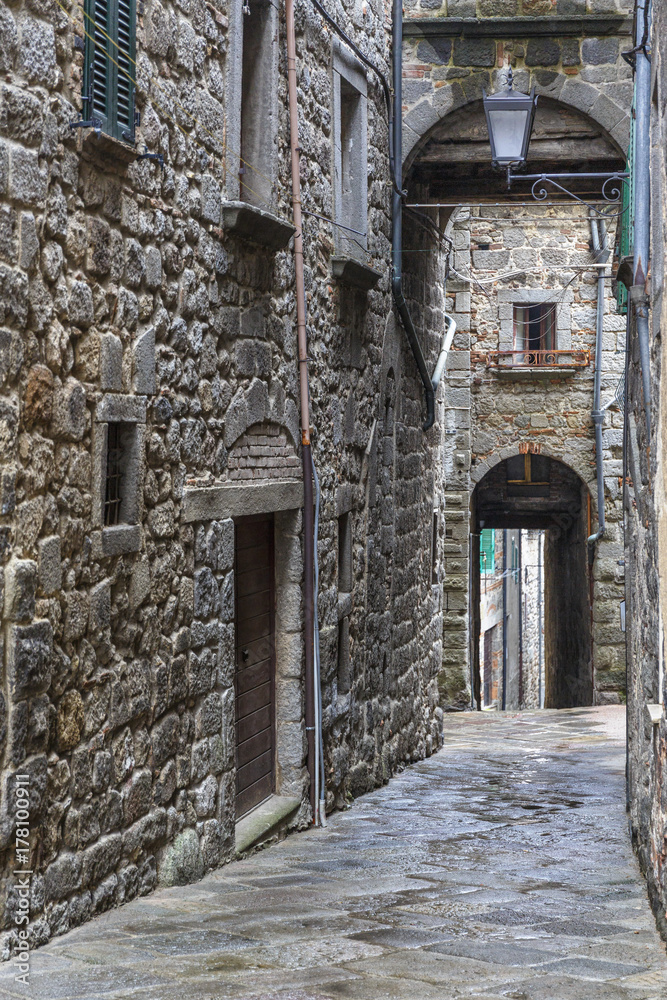 Dark alley in an old Italian city