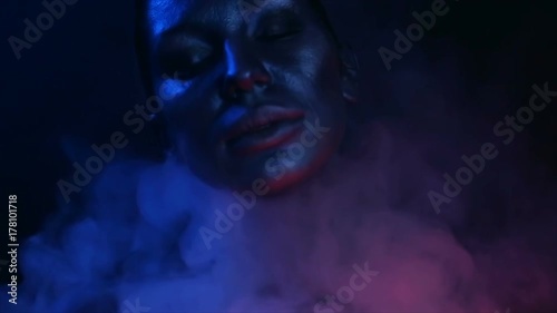 Halloween night. Horror Party. Beautiful Sexy Young vamp Woman with glamorous mystical makeup half-face. Terrible goddess. Girl Blue mystic light. Furious Lilith.