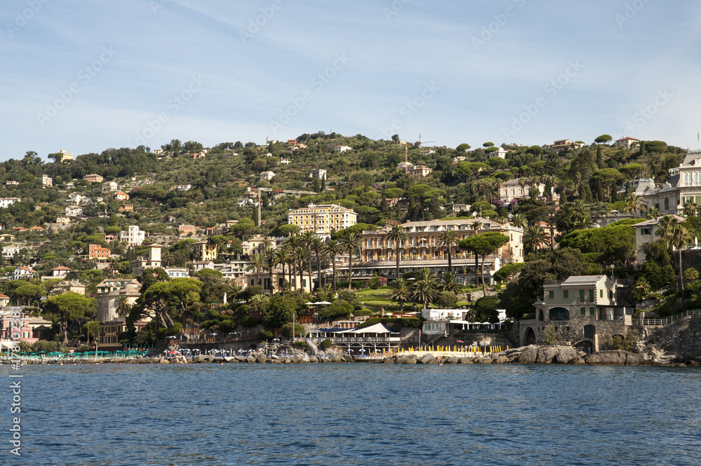 Santa Margherita Ligure, Liguria Italia -  watching the coast from the sea. the Village with the typical architecture of the houses just behind the beaches
