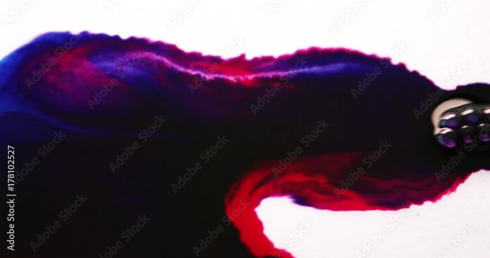 Red and blue ink mixing together on white. Abstract background