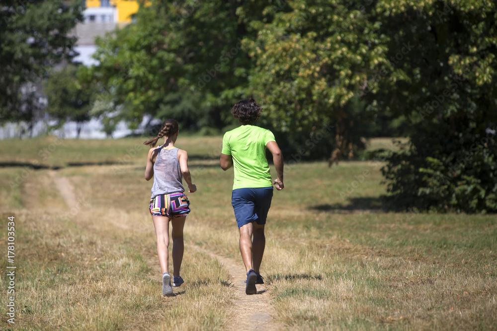 Healthy, fit and sportive couple running in park Healthy, fit and sportive couple running in park