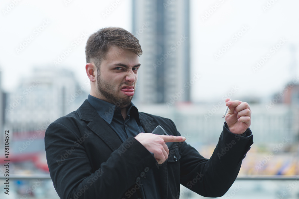 A cute man does not like cigarettes. A man holds a cigarette in his arms and curls. Cigarette is evil A cute man does not like cigarettes. A man holds a cigarette in his arms and curls. Cigarette is evil