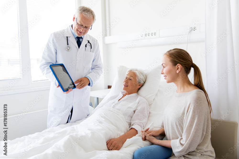 Fototapeta premium senior woman and doctor with tablet pc at hospital