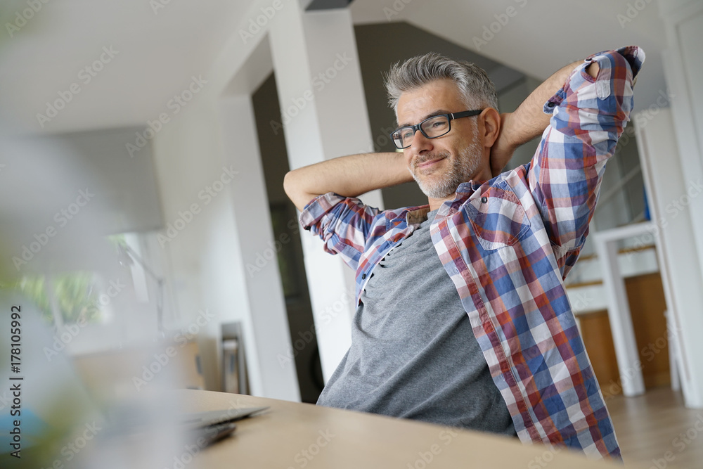 Fototapeta premium Home-office worker stretching arms in front of laptop