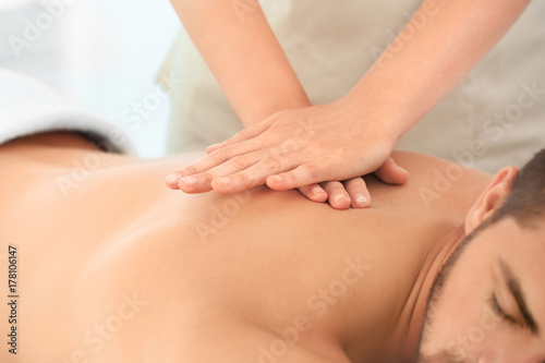 Young man having massage in...