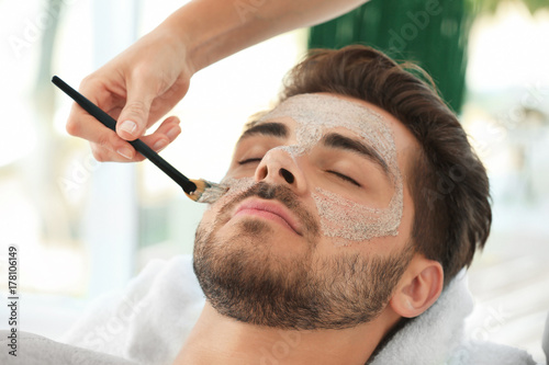 Beautician applying scrub o...