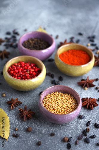 Fototapeta Naklejka Na Ścianę i Meble -  Spices in containers on a gray background