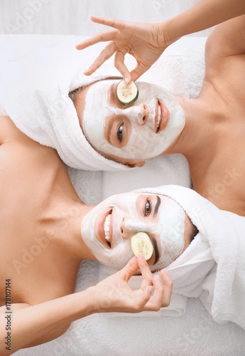 Young women with facial mas...