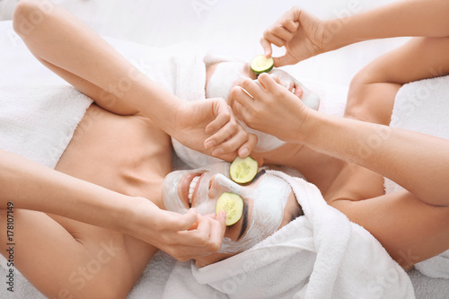 Young women with facial mas...