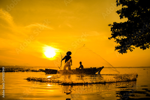 Fishermen who are fishing in the river and a silhouette