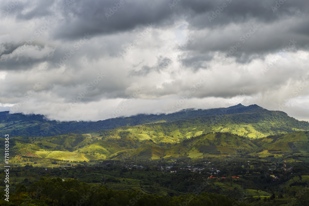 Rocky valley in forest and wooded landscape with rain clouds Rocky valley in forest and wooded landscape with rain clouds
