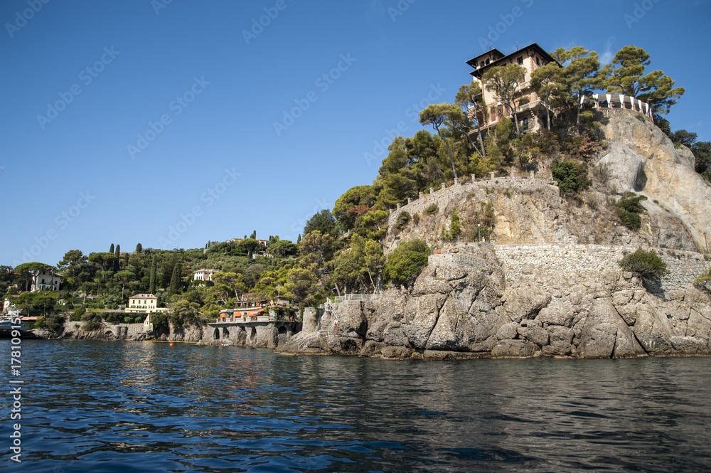 Portofino, Liguria Italia - watching the coast from the sea. View of the Portofino Villa Odero Clastle with crystalline waters