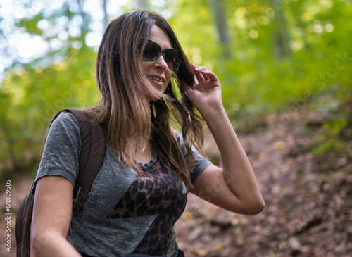 Woman hiking on a trail in the woods
