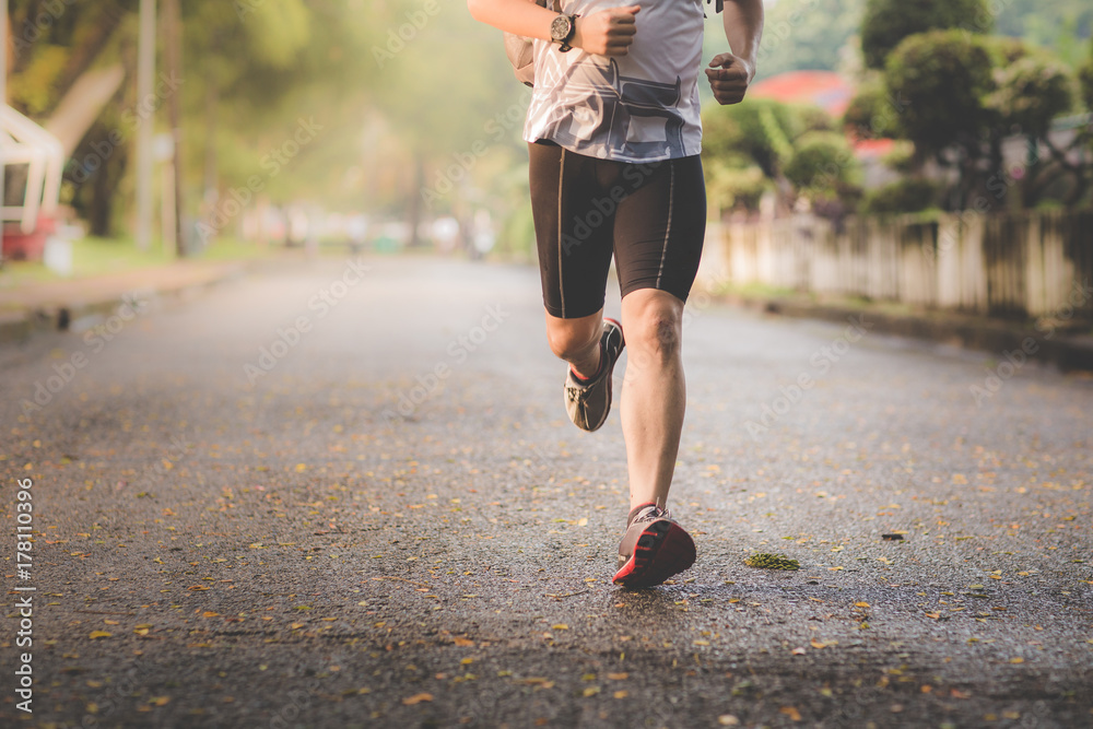 Fototapeta premium Athlete man runner running legs closeup on shoe,Men jogging in a park.