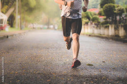 Athlete man runner running legs closeup on shoe,Men jogging in a park.