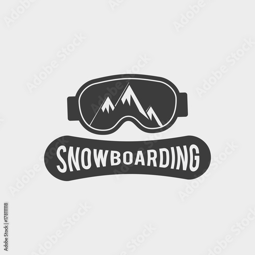 Snowboard club logo, label or badge template. Snowboarding symbol with snowboard glasses and mountainsin reflection. WInter extreme sport. photo