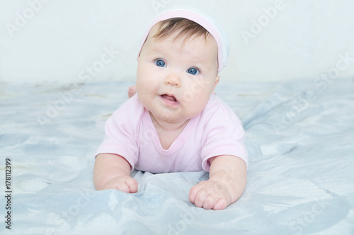Happy smiling baby girl portrait with wryneck. Health care lifestyle.