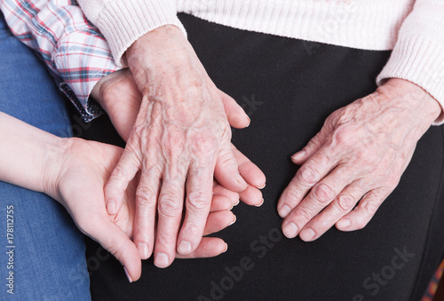 Care of senior woman at home sitting on the couch