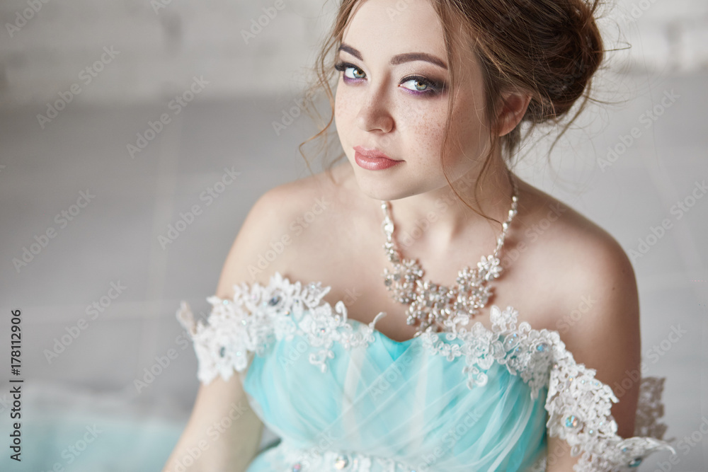 Happy Pregnant woman in long evening dress touching belly hands. Waiting the birth of a child, a woman in her eighth month of pregnancy. Luxurious pregnant girl in a dress of azure color