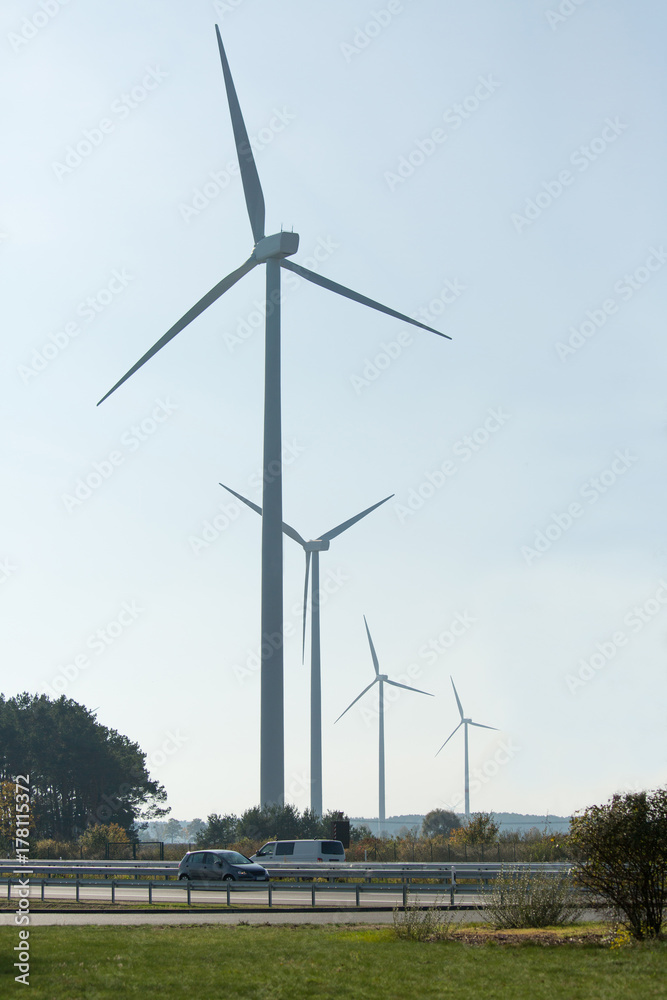Wind turbines near highway. Clean energy concept. 