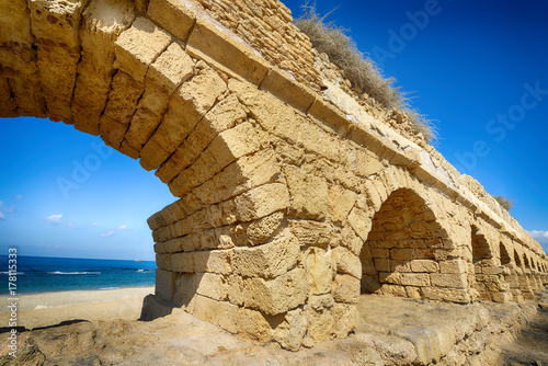 Ancient Roman aqueduct at Caesarea photo