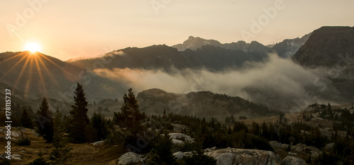 Sunrise and fog in the mountains of Wyoming photo