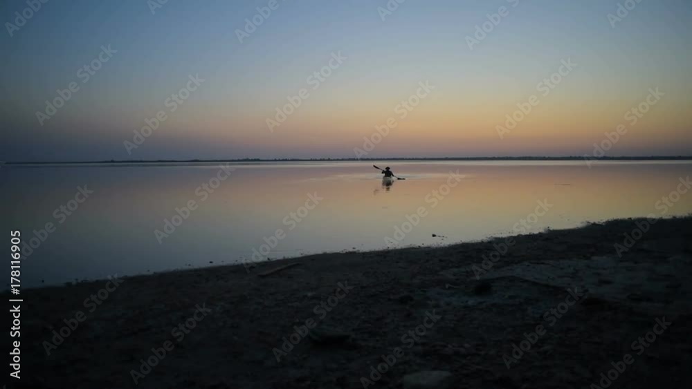 man kayaking on lake during sunset man kayaking on lake during sunset