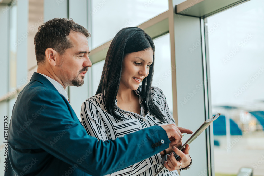 Man and woman talking about contract in car dealership. Man and woman talking about contract in car dealership.